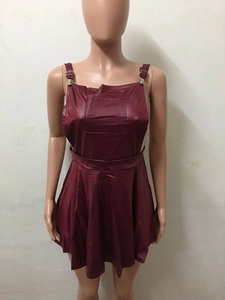 Detail view of maroon faux leather dress featuring adjustable metal buckles and a front pocket