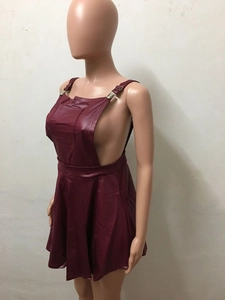 Detail view of burgundy PU leather mini dress featuring side cutouts and metal buckles
