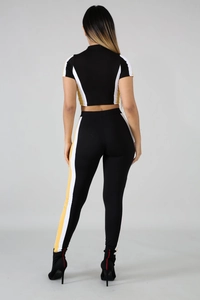 Detail view of the slim-fit sporty two-piece set with yellow and white side stripes