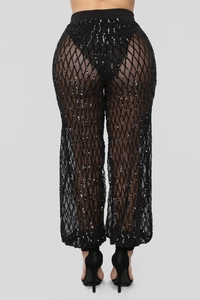 Vue détaillée du dos d'un pantalon noir à paillettes taille haute avec motif à carreaux