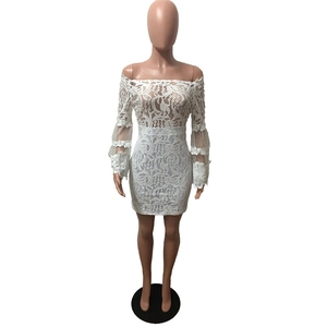 Detail of white lace off-shoulder dress with intricate floral embroidery and long sleeves