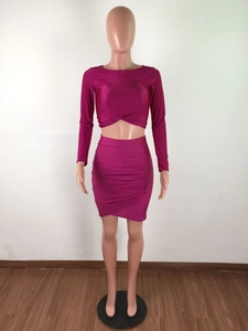Detail of burgundy ruched mini skirt and long sleeve crop top with front knot detail