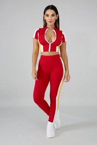 Detail of red two-piece tracksuit with contrast white and yellow side stripe panels