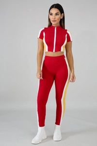 Detail of red color-block two-piece sports set with contrast side stripes and zipper
