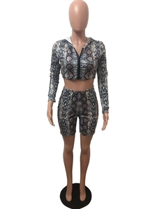 Detail of snake skin print two-piece set featuring hooded zip jacket and high waist shorts