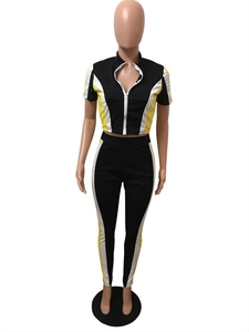 Detail of a two-piece sporty set featuring contrast paneling and half-zip short sleeve top