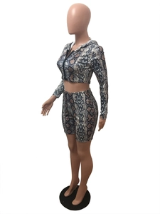 Detail view of snakeskin print crop top and matching biker shorts on a mannequin