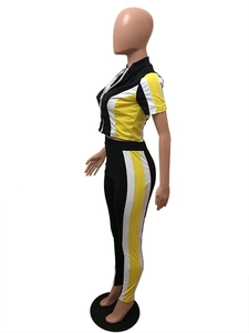 Detail of two-piece tracksuit featuring color-block panels and stand collar zipper design