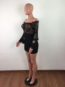 Detail of black lace off-shoulder dress featuring sheer long sleeves and floral patterns