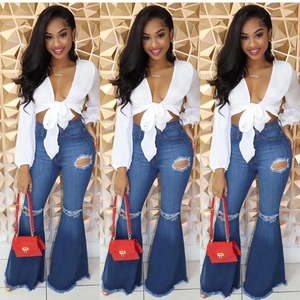 Women's high waist flared jeans with distressed knee holes and fringe hem design