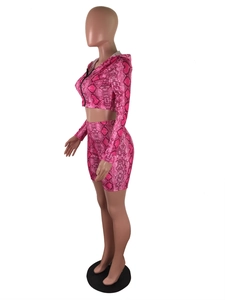 Close-up of pink snakeskin pattern fabric on the hooded zip-up crop top and shorts