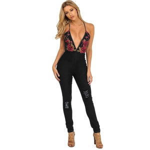 Women's black backless denim jumpsuit with floral embroidery and distressed ripped knees