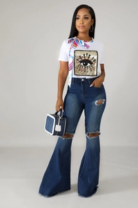 Close-up of distressed denim jeans with frayed hems and knee rips for a retro look