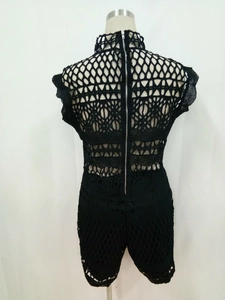 Detail view of the back zipper and geometric hollow knit pattern on this black jumpsuit