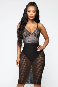 Detail of elegant black lace V-neck bodice with translucent mesh skirt and high waist