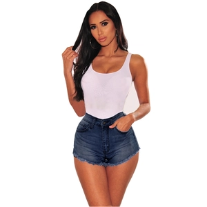 Detail of high waisted distressed denim shorts with frayed edges and white ribbed tank top