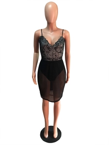 Detail of the black floral lace V-neckline and sheer mesh bodice on a formal dress