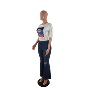Detail of high-waist flare jeans with distressed knee holes and frayed hem style