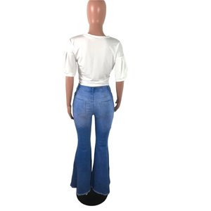 Detail view of high waist flare jeans featuring distressed frayed hems and back pockets