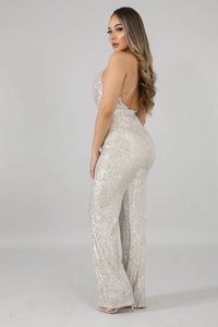 Detail shot of shimmering sequin jumpsuit featuring backless design and wide leg cut