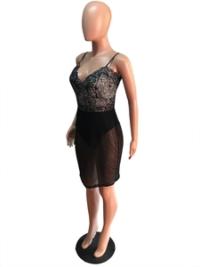 Detail of elegant black lace bodice and sheer mesh skirt on a form-fitting mini dress