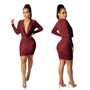 Close-up of wine red sequin dress featuring a deep V-neck and sparkling metallic texture