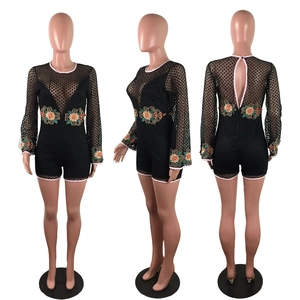Detailed back view of lace bodysuit featuring floral embroidery and open back design