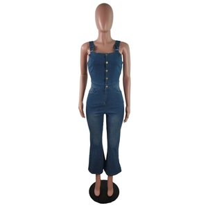 Close-up of slim fit denim jumpsuit with gold buttons and flare leg design