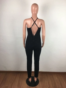 Close-up of the back cross-straps and invisible zipper on black denim jumpsuit