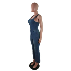 Detail of slim fit denim jumpsuit featuring metal adjustable straps and front buttons
