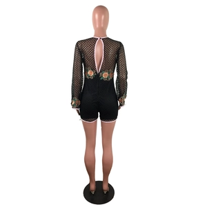 Detailed back view of black lace romper with floral embroidery and cutout design