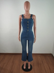 Detail of female denim jumpsuit with gold buttons and high waist flared pant leg design