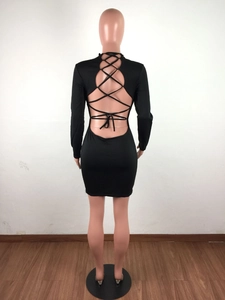 Detail of sexy backless mini dress featuring intricate criss-cross bandage design