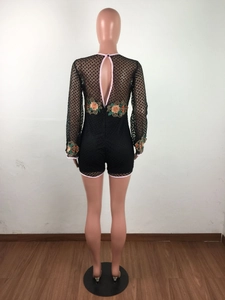 Detailed back view of lace bodysuit with cutout and floral embroidery on sleeves