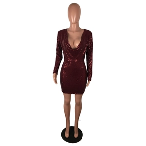 Detailed view of deep V-neck and sparkling sequins on a wine red long sleeve dress