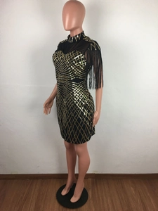 Detail of black mini dress with gold sequins, mesh splice and shoulder tassels