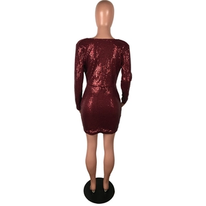 Macro detail of wine red sequin dress showing deep burgundy fabric and shiny texture