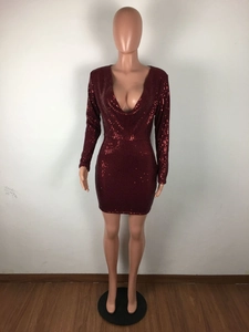 Detail of burgundy sequin mini dress with deep V-neck and sparkling light-reflecting texture