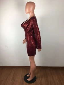 Detail of burgundy sequin mini dress showing reflective texture and cowl neckline