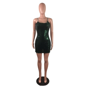 Close-up detail of dark green sequins on a slim fit cocktail mini dress with straps