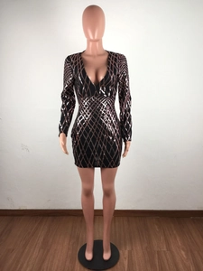 Detail of rose gold sequin rhombus pattern on a black bodycon dress with deep V-neck