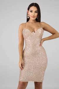 Detailed macro view of champagne gold sequins on a bodycon mini dress with chain straps