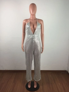 Detail of silver sequined jumpsuit featuring a deep V-neck and sparkling metallic texture
