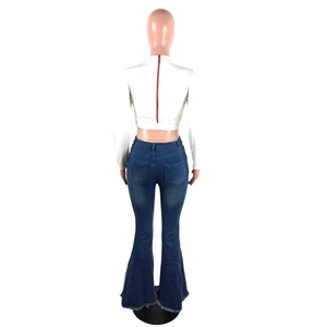 Detail of high-waisted flared jeans with frayed hems and back red zipper top
