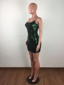 Detail of green sequin mini dress showing the shimmering texture and slim fit design
