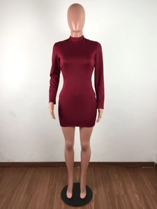 Detail of burgundy long sleeve bodycon dress showing sleek fabric and mock neck design