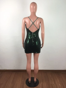 Detail of cross straps and back zipper on a dark green sequined slim mini dress
