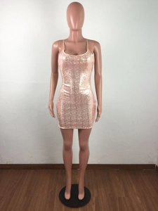 Close-up of champagne pink sequin fabric and slim spaghetti straps on a bodycon mini dress