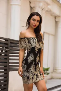 Détails de robe noire à épaules dénudées avec broderie de dentelle baroque dorée
