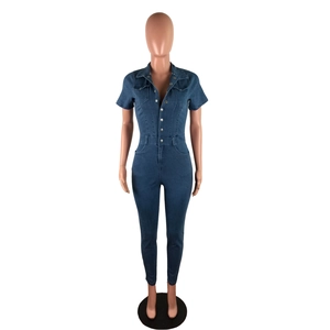 Detail of dark blue denim jumpsuit with short sleeves, lapel collar and metal buttons